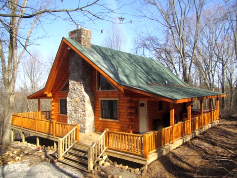 sunny day with cabin in the woods with green roof