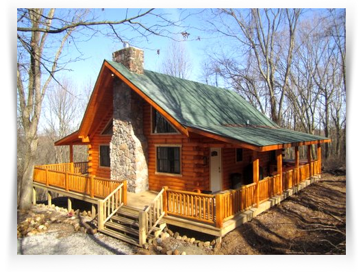 log cabin with wrap around porch and green roof