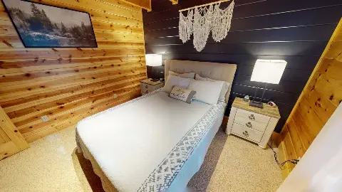 Queen bed with macrame wall hanging and nightstands