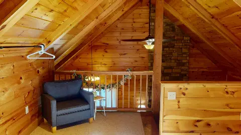Loft sitting area with armchair overlooking the living room