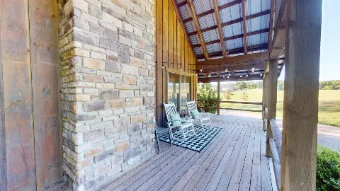 Porch rocking chairs beside the stone chimney