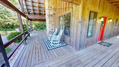 Front porch with white rocking chairs and red front door