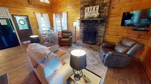 Open living area with fireplace, dining table and front door
