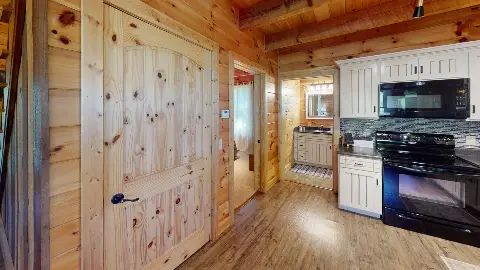 Hallway to the bedroom and bathroom beside the kitchen