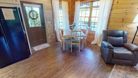 Dining table by the windows next to the front door